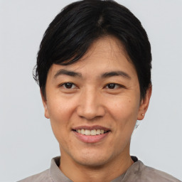 Joyful asian adult male with short  black hair and brown eyes