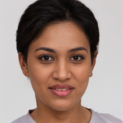 Joyful latino young-adult female with short  brown hair and brown eyes