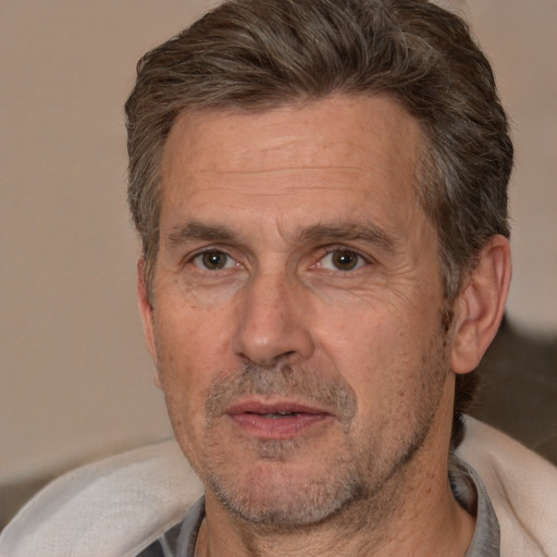 Joyful white middle-aged male with short  brown hair and brown eyes