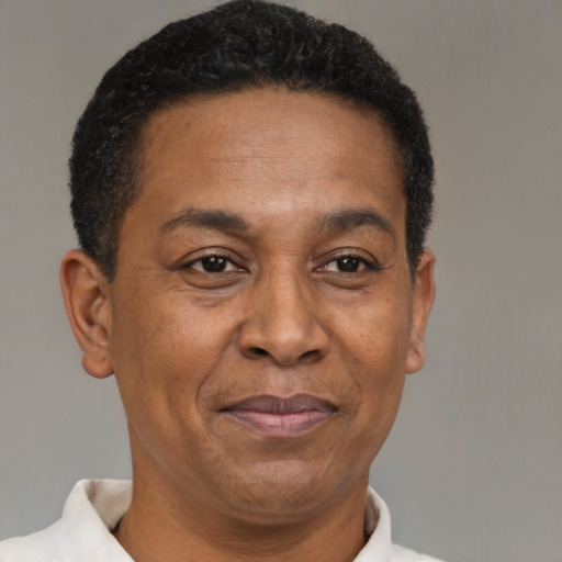 Joyful latino adult male with short  black hair and brown eyes