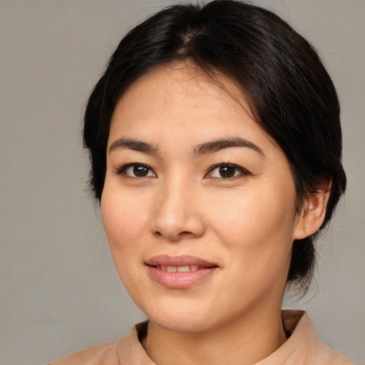 Joyful asian young-adult female with medium  brown hair and brown eyes