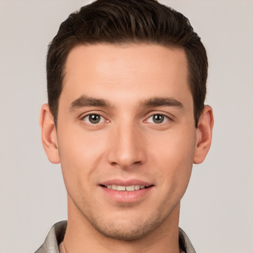 Joyful white young-adult male with short  brown hair and brown eyes