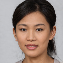 Joyful asian young-adult female with medium  black hair and brown eyes