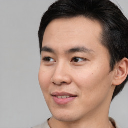 Joyful asian young-adult male with short  brown hair and brown eyes