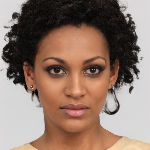 Neutral black young-adult female with medium  brown hair and brown eyes