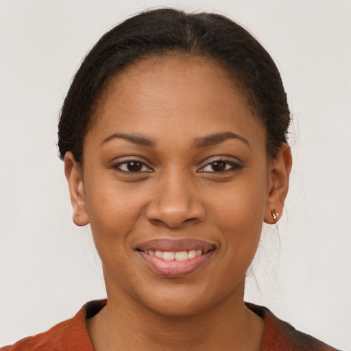 Joyful black young-adult female with short  brown hair and brown eyes