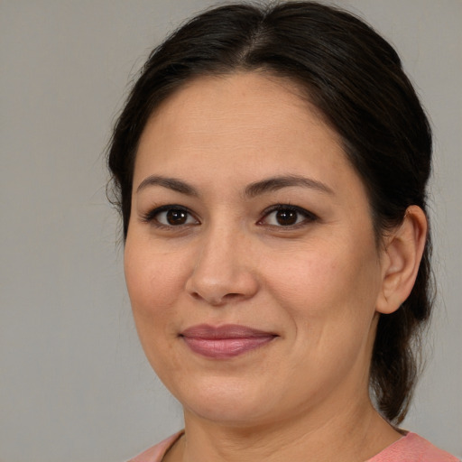 Joyful latino adult female with medium  brown hair and brown eyes