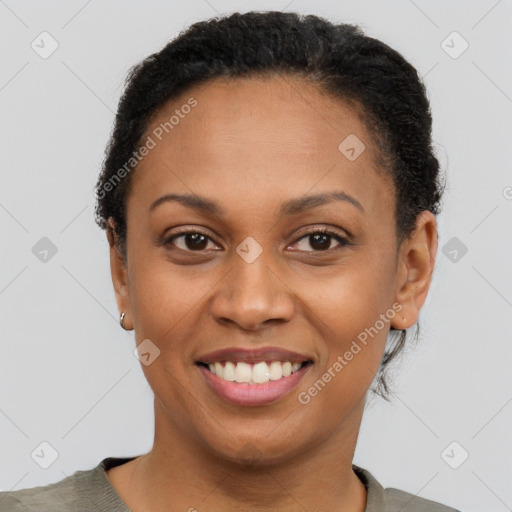 Joyful black adult female with short  brown hair and brown eyes