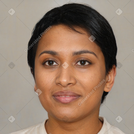 Joyful black young-adult female with short  black hair and brown eyes