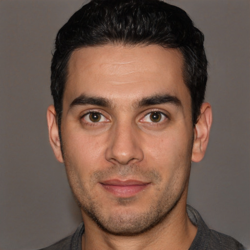 Joyful white young-adult male with short  brown hair and brown eyes