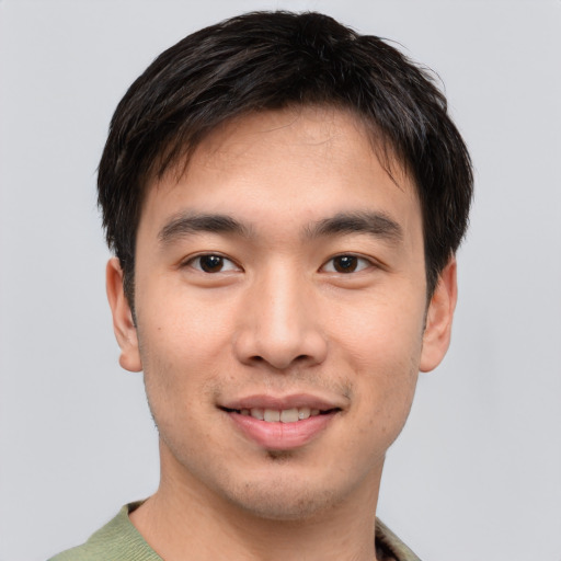 Joyful asian young-adult male with short  brown hair and brown eyes