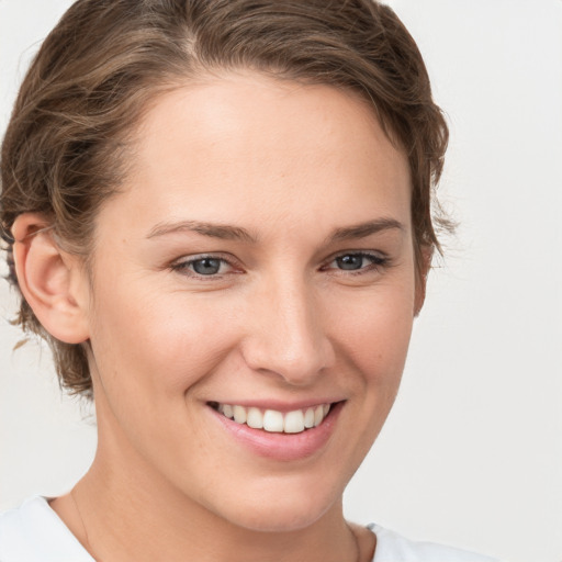 Joyful white young-adult female with short  brown hair and brown eyes