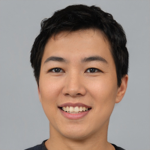 Joyful asian young-adult male with short  black hair and brown eyes
