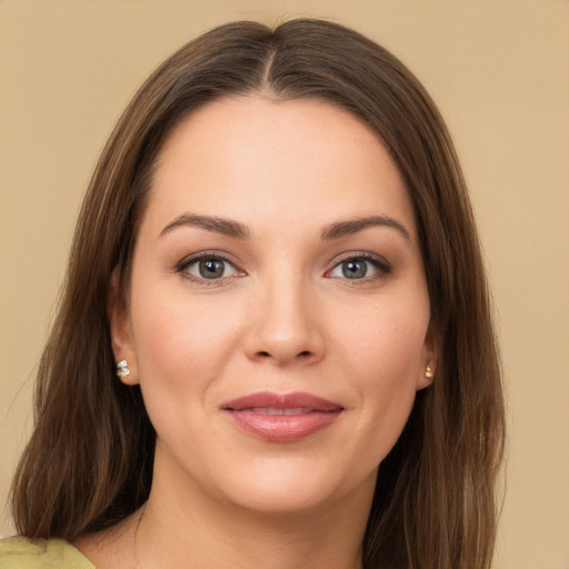 Joyful white young-adult female with long  brown hair and brown eyes