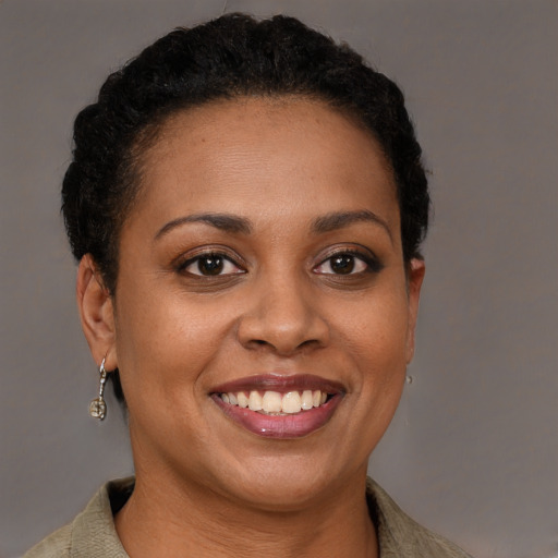 Joyful black young-adult female with short  brown hair and brown eyes