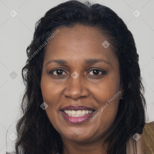 Joyful black adult female with long  brown hair and brown eyes