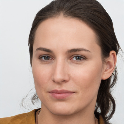 Joyful white young-adult female with long  brown hair and grey eyes