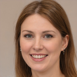 Joyful white young-adult female with long  brown hair and grey eyes