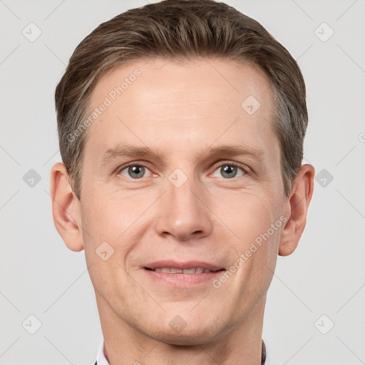 Joyful white adult male with short  brown hair and grey eyes