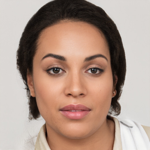 Joyful latino young-adult female with long  brown hair and brown eyes