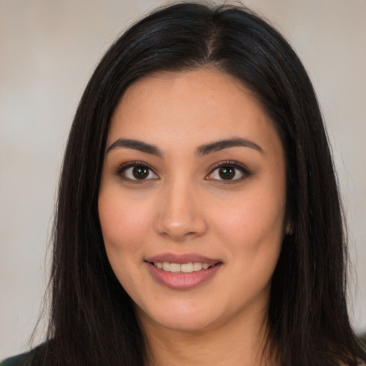 Joyful latino young-adult female with long  brown hair and brown eyes