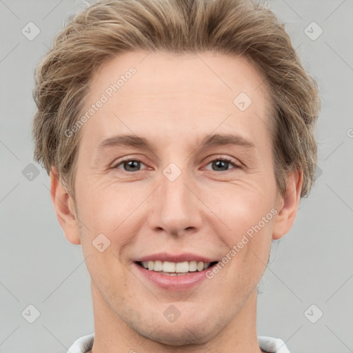 Joyful white adult male with short  brown hair and grey eyes