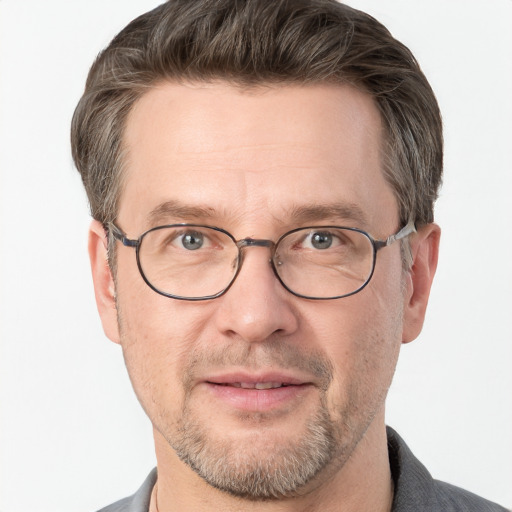 Joyful white adult male with short  brown hair and grey eyes