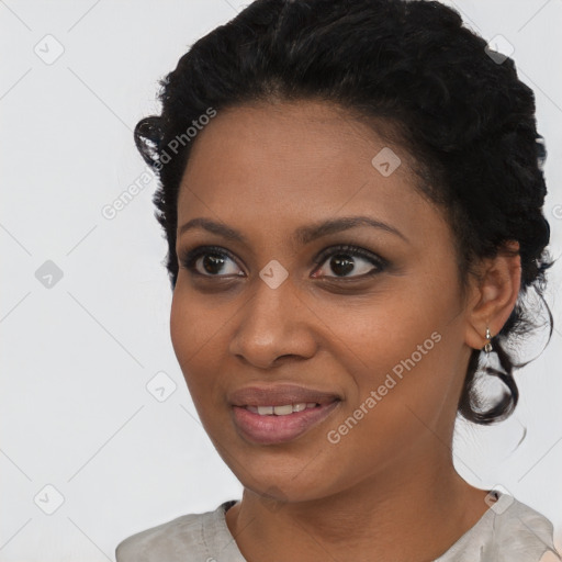 Joyful black young-adult female with short  black hair and brown eyes