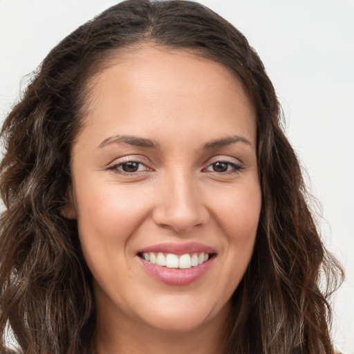 Joyful white young-adult female with long  brown hair and brown eyes