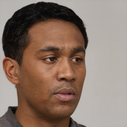 Neutral black young-adult male with short  black hair and brown eyes
