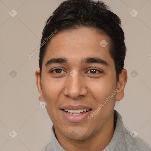 Joyful white young-adult male with short  black hair and brown eyes