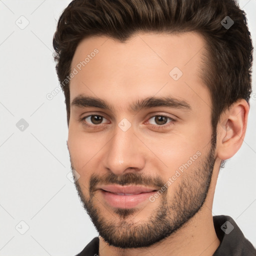 Joyful white young-adult male with short  brown hair and brown eyes