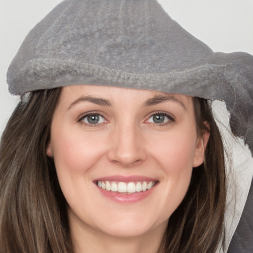 Joyful white young-adult female with long  brown hair and grey eyes