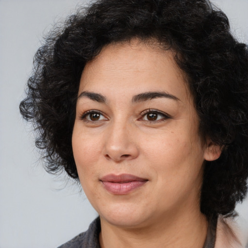Joyful white young-adult female with medium  black hair and brown eyes