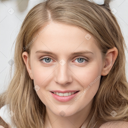 Joyful white young-adult female with long  brown hair and blue eyes