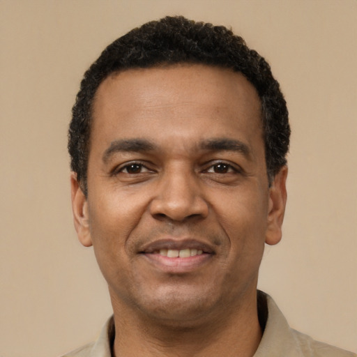 Joyful latino adult male with short  black hair and brown eyes