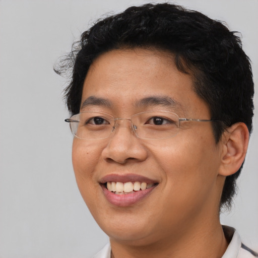 Joyful asian adult male with short  brown hair and brown eyes