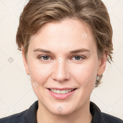 Joyful white young-adult female with short  brown hair and grey eyes