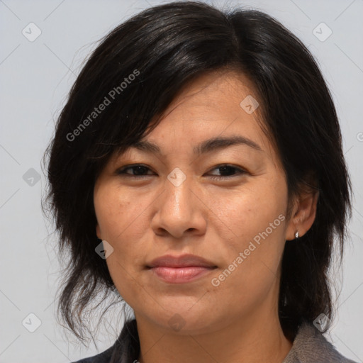 Joyful asian adult female with medium  brown hair and brown eyes