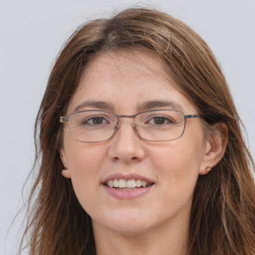 Joyful white adult female with long  brown hair and grey eyes