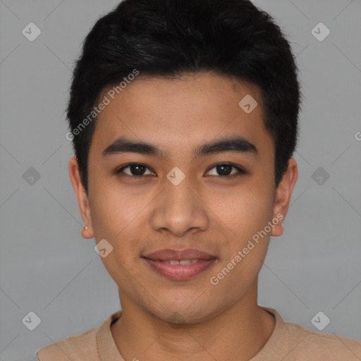 Joyful latino young-adult male with short  black hair and brown eyes