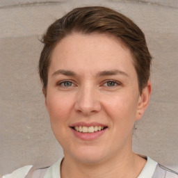 Joyful white young-adult female with short  brown hair and grey eyes