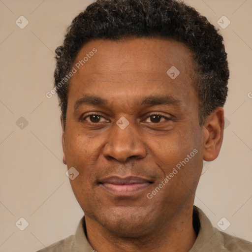 Joyful black adult male with short  brown hair and brown eyes