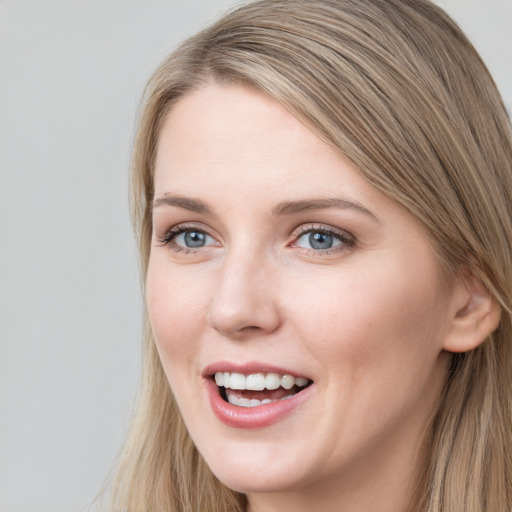 Joyful white young-adult female with long  brown hair and grey eyes