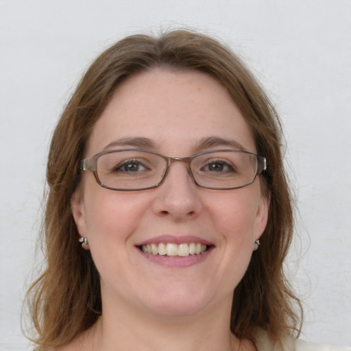 Joyful white young-adult female with medium  brown hair and blue eyes