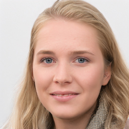 Joyful white young-adult female with long  brown hair and blue eyes