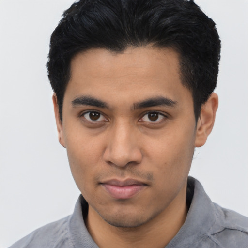 Joyful asian young-adult male with short  black hair and brown eyes