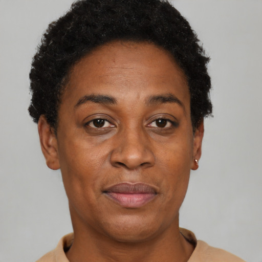 Joyful black adult female with short  brown hair and brown eyes
