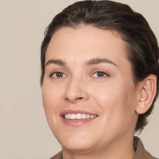 Joyful white young-adult female with medium  brown hair and brown eyes