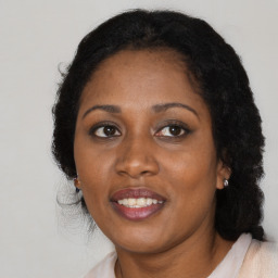 Joyful black adult female with medium  brown hair and brown eyes